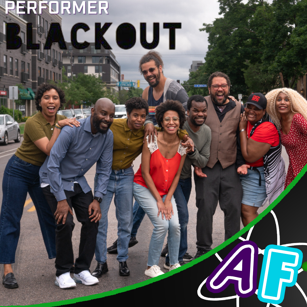 A group of performers posing and smiling at the camera. Text on the photo reads: "Performer: Blackout" with the comedy troupe's logo serving as the text