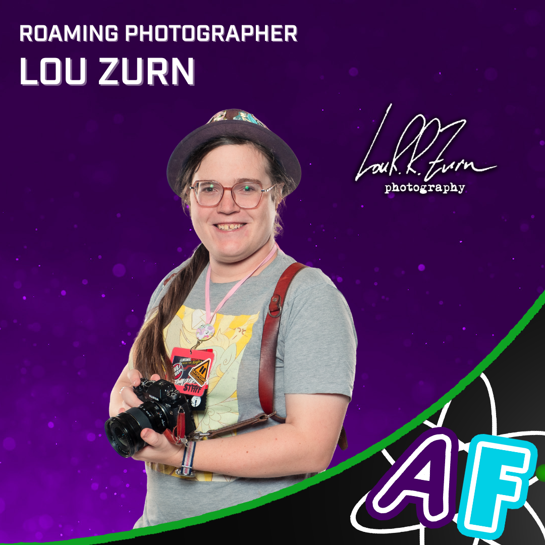 A smiling woman holding a camera, with the logo "Lou R. R. Zurn Photography" to her left. Text on photo reads: "Roaming photographer: Lou Zurn"
